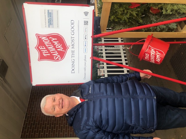 Image of Colonial Federal Savings Bank President and CEO Mike McFarland, ringing The Salvation Army bell for donations.
